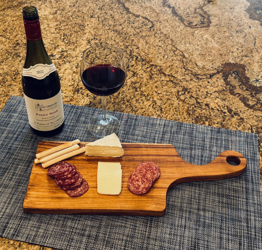 Canary charcuterie board with wine, cheese, and appetizers on kitchen countertop