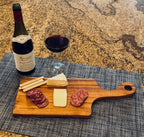 Canary charcuterie board with wine, cheese, and appetizers on kitchen countertop