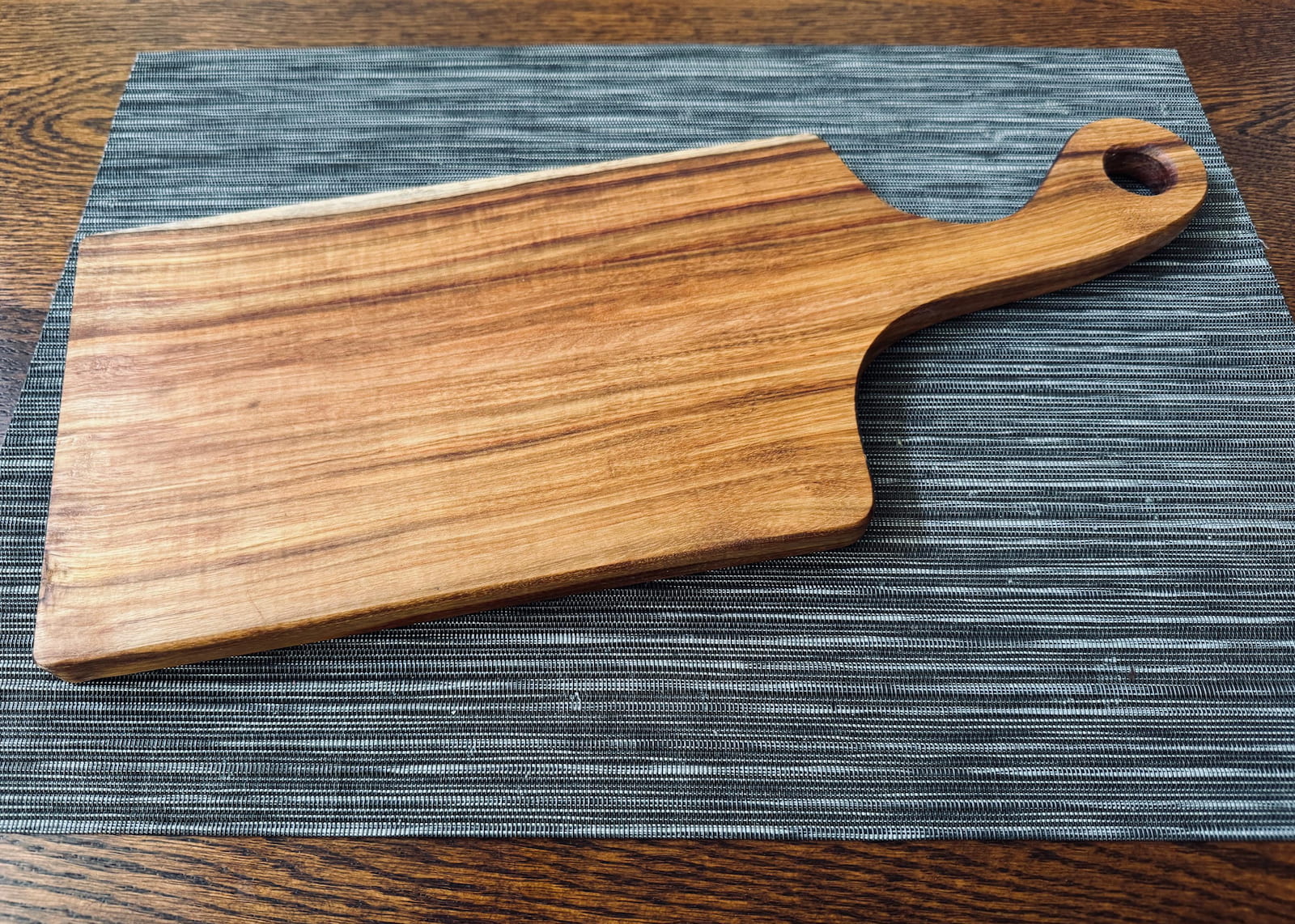 Handcrafted canary wood charcuterie serving board with handle