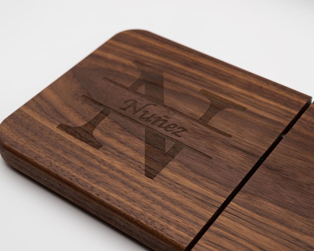 Close-up of engraved split monogram family name design on personalized walnut cheese slicer