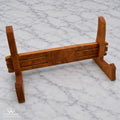 Handcrafted hardwood cutting board stand shown assembled from an angled front view