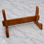 Handcrafted hardwood cutting board stand shown assembled from an angled front view