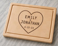 Maple end grain cutting board with engraved heart design, couple names, and anniversary date