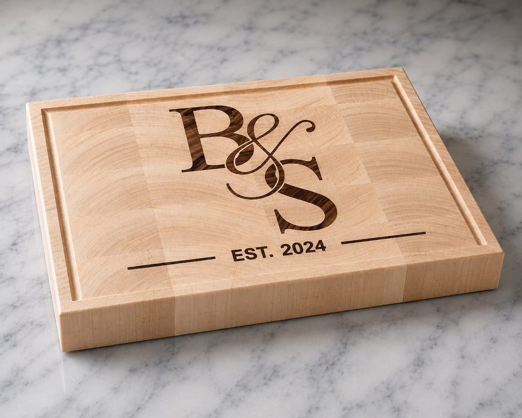 Maple end grain cutting board with walnut couples monogram inlay and established 2024 engraving