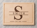 Maple end grain cutting board with walnut split monogram inlay, family name, and established 2001 engraving