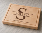 Maple end grain cutting board with walnut inlay split monogram design featuring the Smith family name and established 2001 engraving