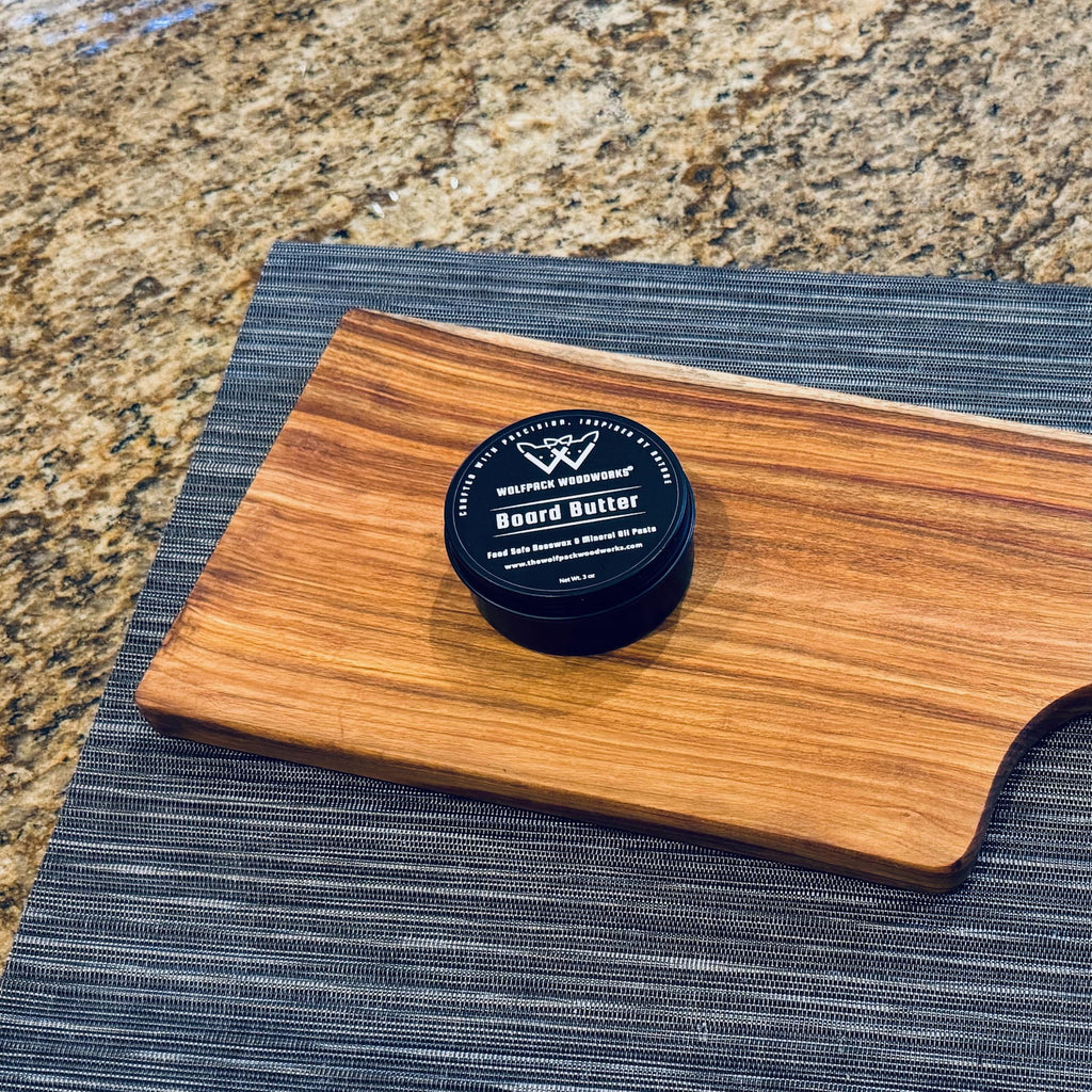 Organic beeswax board butter wood conditioner on handcrafted canary wood serving board