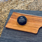 Organic beeswax board butter wood conditioner on handcrafted canary wood serving board