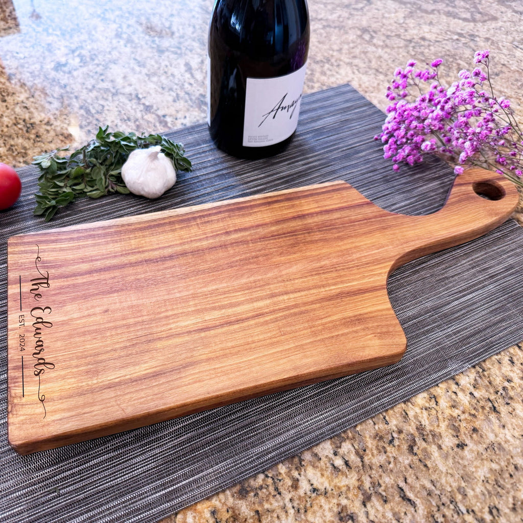 Personalized canary wood charcuterie serving board with engraved family name and wine bottle