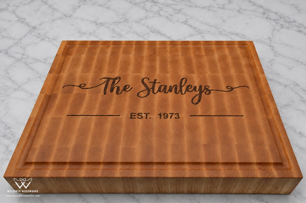 Personalized maple end grain board featuring Stanley family name, established date, and decorative inlay design
