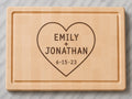 Personalized maple end grain cutting board with walnut love story inlay, two names, and special date.
