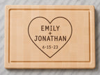 Personalized maple end grain cutting board with walnut love story inlay, two names, and special date.