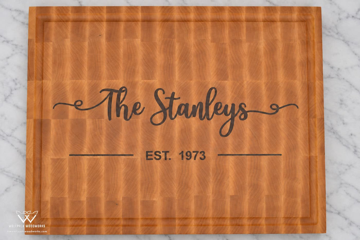 Top view of personalized maple end grain cutting board with Stanley family name and established date inlay