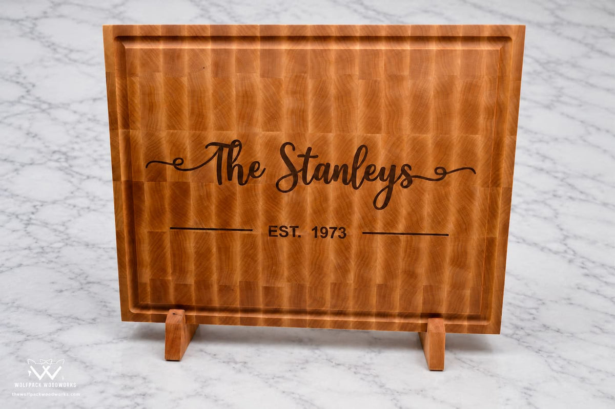 Personalized maple end grain cutting board with Stanley family name inlay, established date, juice groove, and wood stand