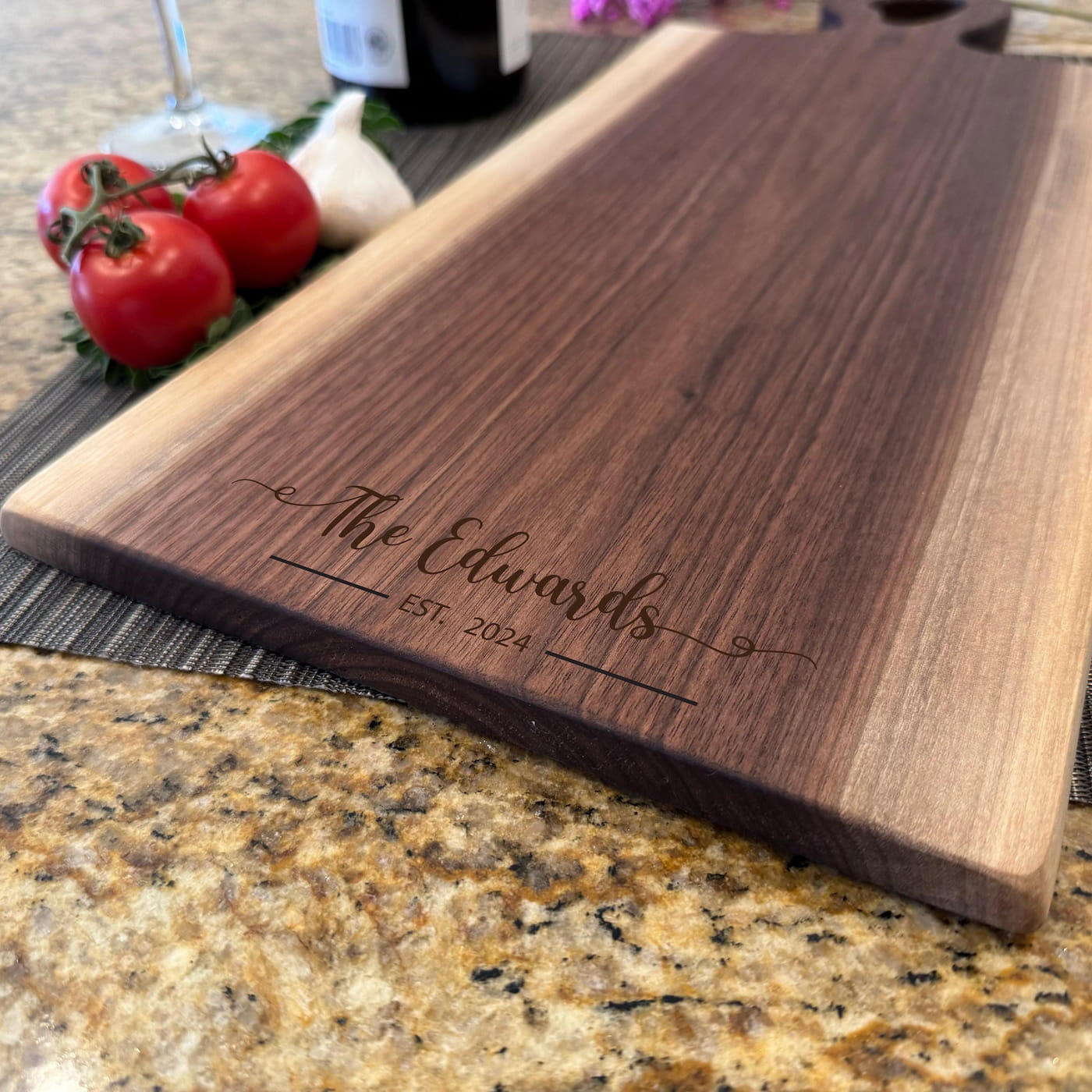 Personalized walnut live edge charcuterie board engraved with family name and establishment date