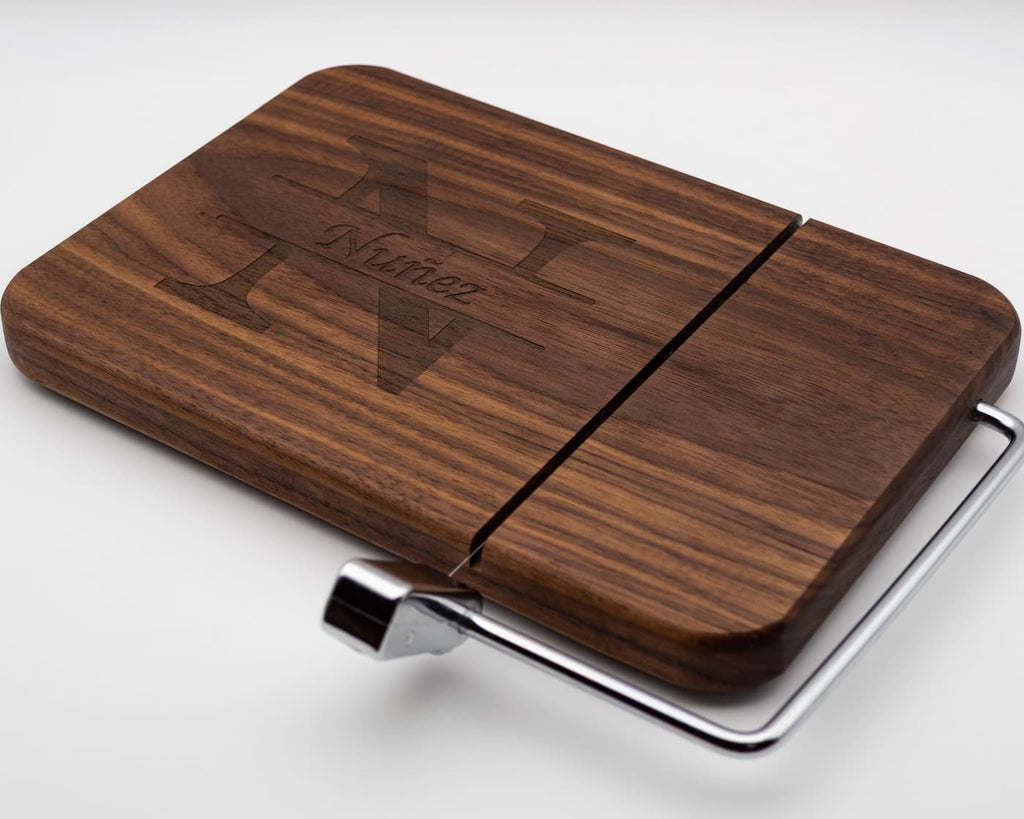 Custom walnut cheese slicer with engraved split monogram family name and stainless steel cutting wire