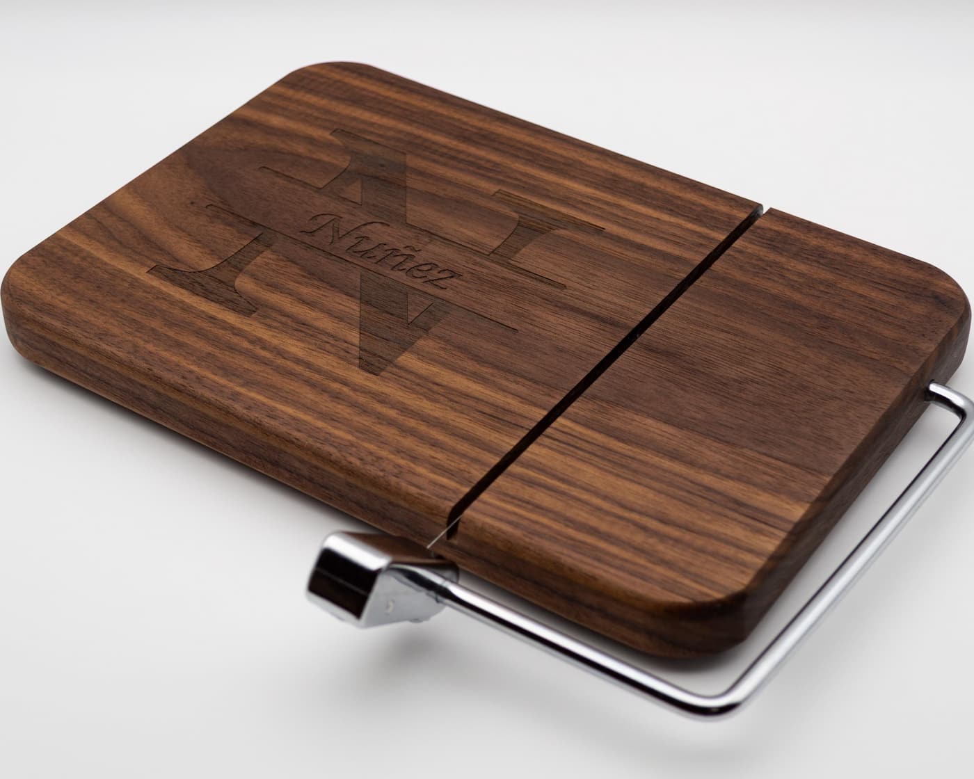 Custom walnut cheese slicer with engraved split monogram family name and stainless steel cutting wire
