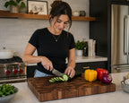 Woman preparing vegetables on handcrafted walnut end grain cutting board in modern kitchen