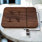 Walnut cheese slicer engraved with split monogram and family name