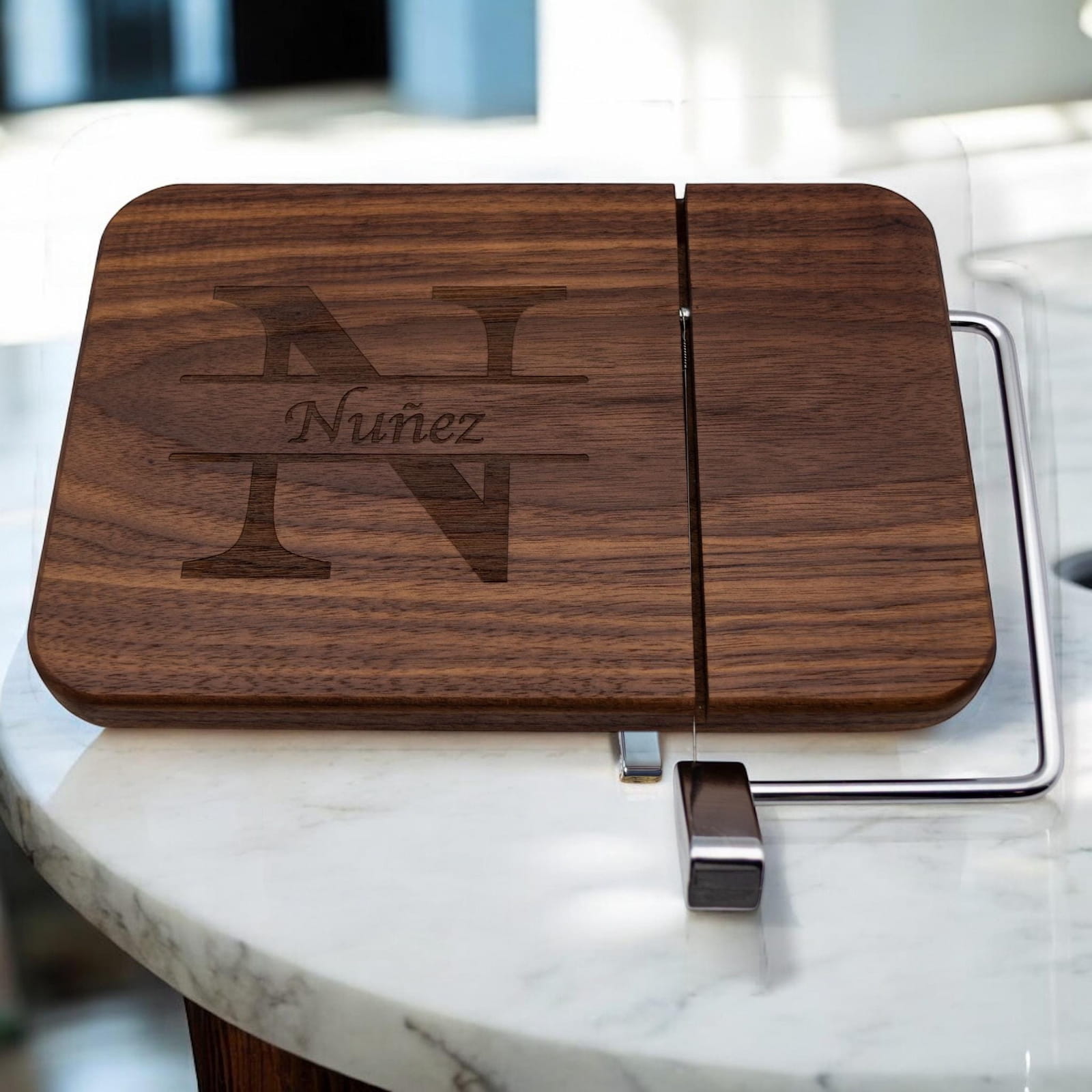 Walnut cheese slicer engraved with split monogram and family name